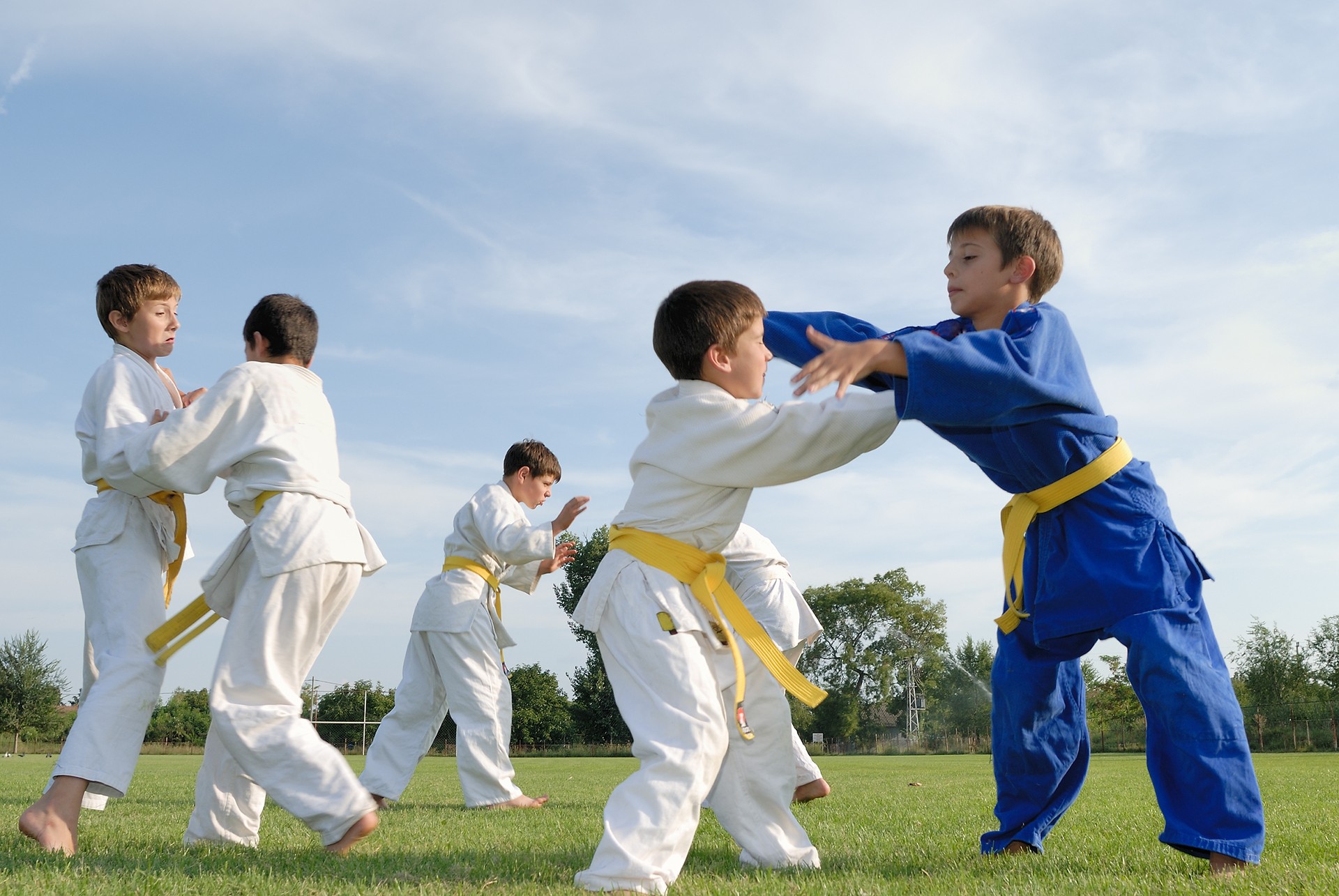 Young boys in white and blue judo gi with yellow belts